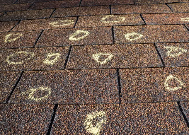 Closeup of hail damage on roof