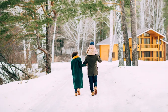 family walking toward home in colorado snow